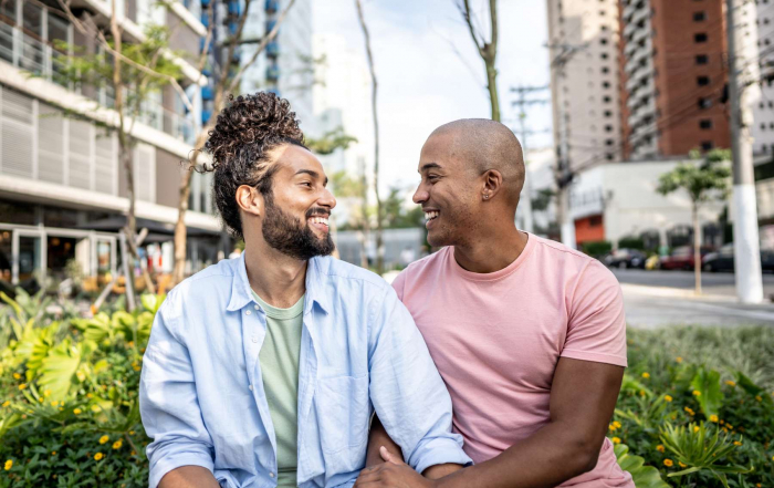 Un duo assis en extérieur, discutant calmement d’un projet de départ en se regardant.