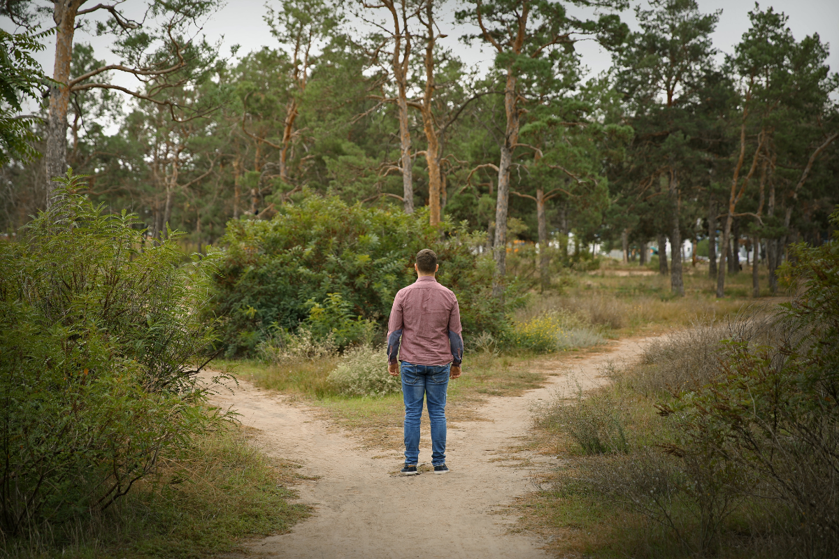 un homme qui hésite entre plusieurs trajectoires
